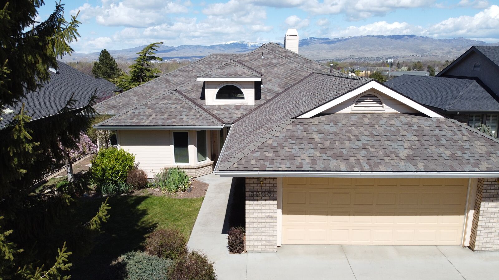 Aerial drone photo of completed roof replacement in Caldwell Idaho mountains backdrop