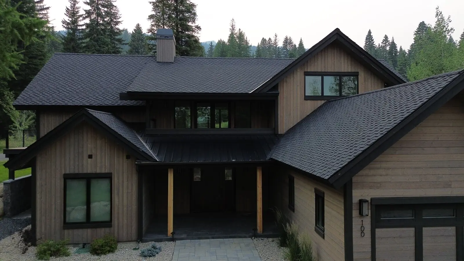 Mountain modern home with new dark shingles and metal accents in Donnelly Idaho - Blue Goat Roofing