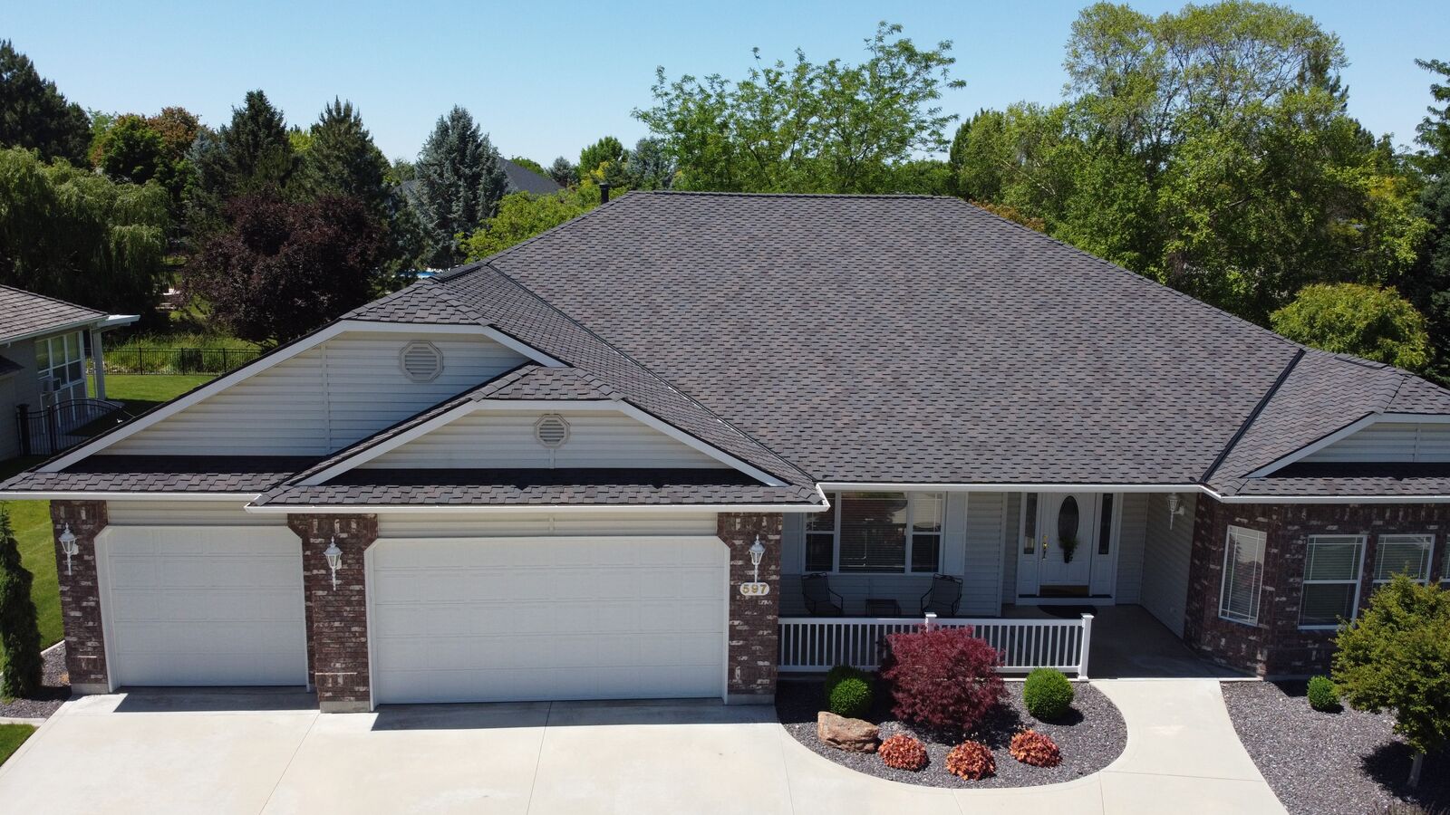 Ranch-style brick home with new charcoal shingle roof in Garden City Idaho