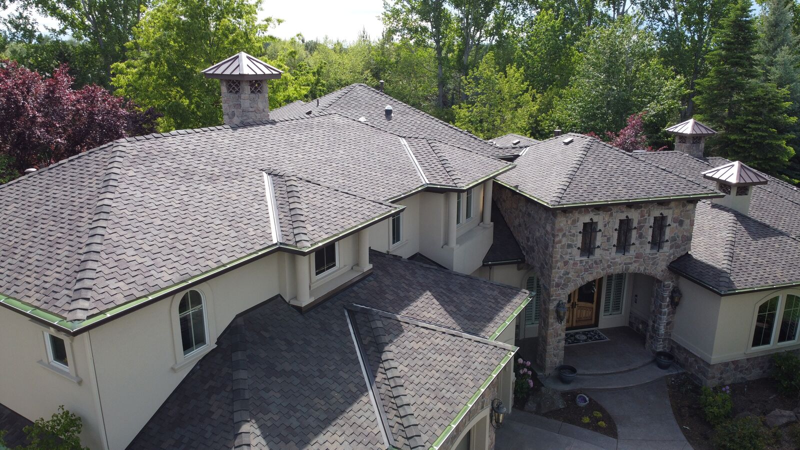 Aerial view of luxury stone estate roof replacement in McCall Idaho