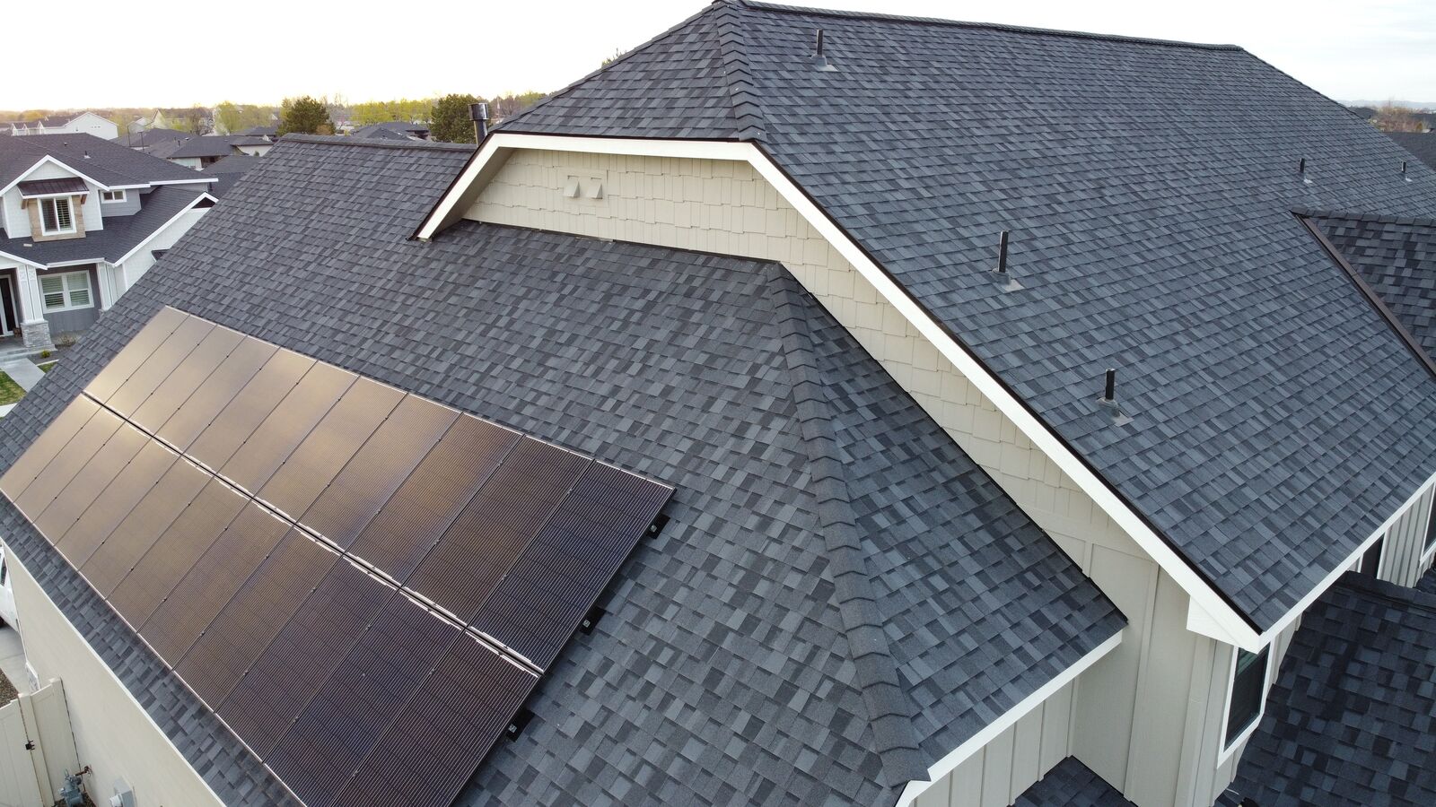 Nampa home with new charcoal shingles and solar panel installation by Blue Goat Roofing