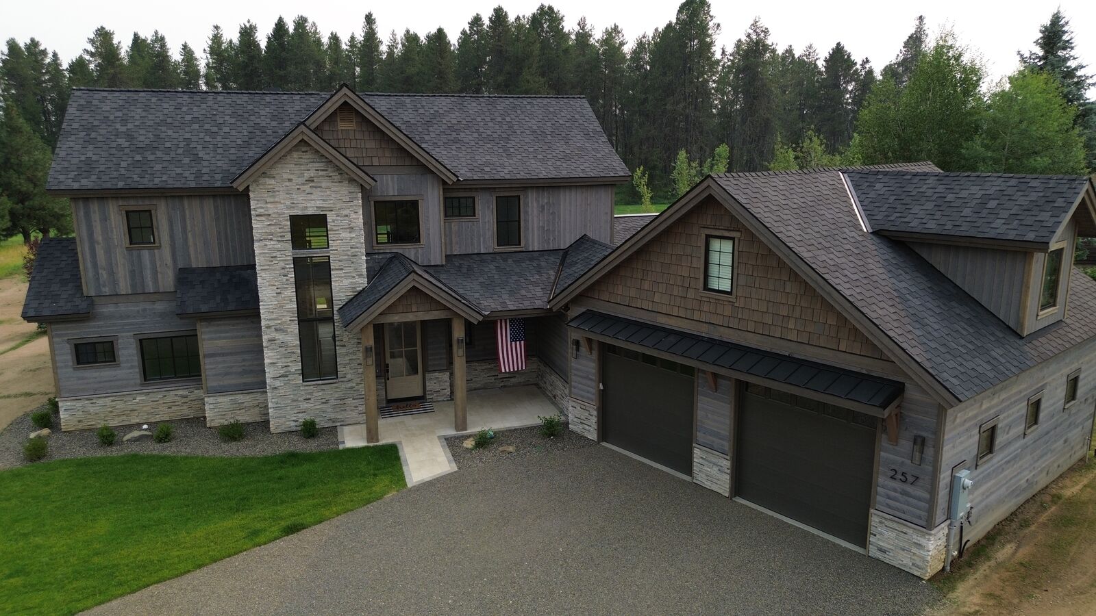 Modern farmhouse home with new charcoal shingles in New Meadows Idaho — Blue Goat Roofing