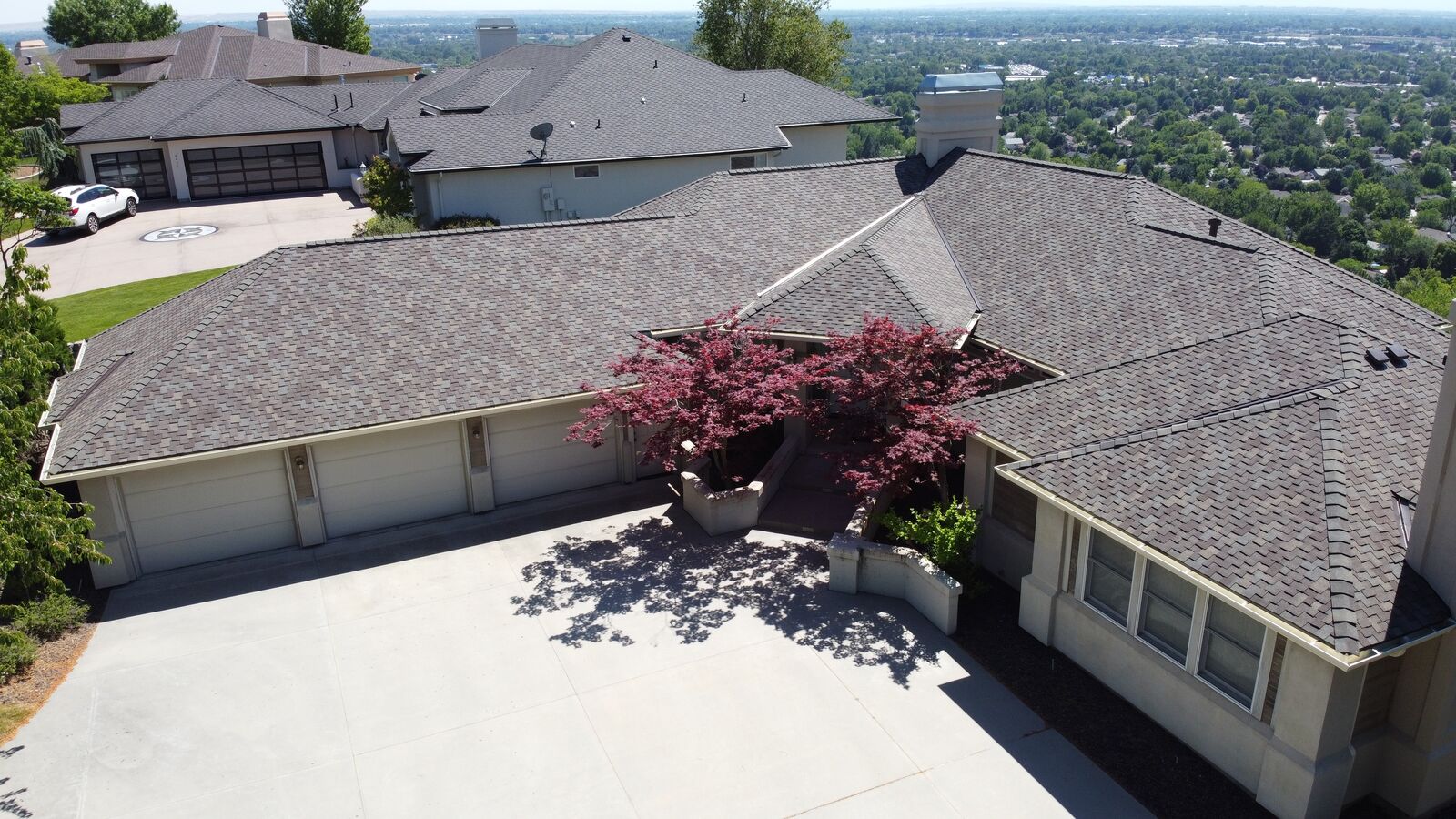 Aerial view of hilltop home with new roof in New Meadows Idaho by Blue Goat Roofing