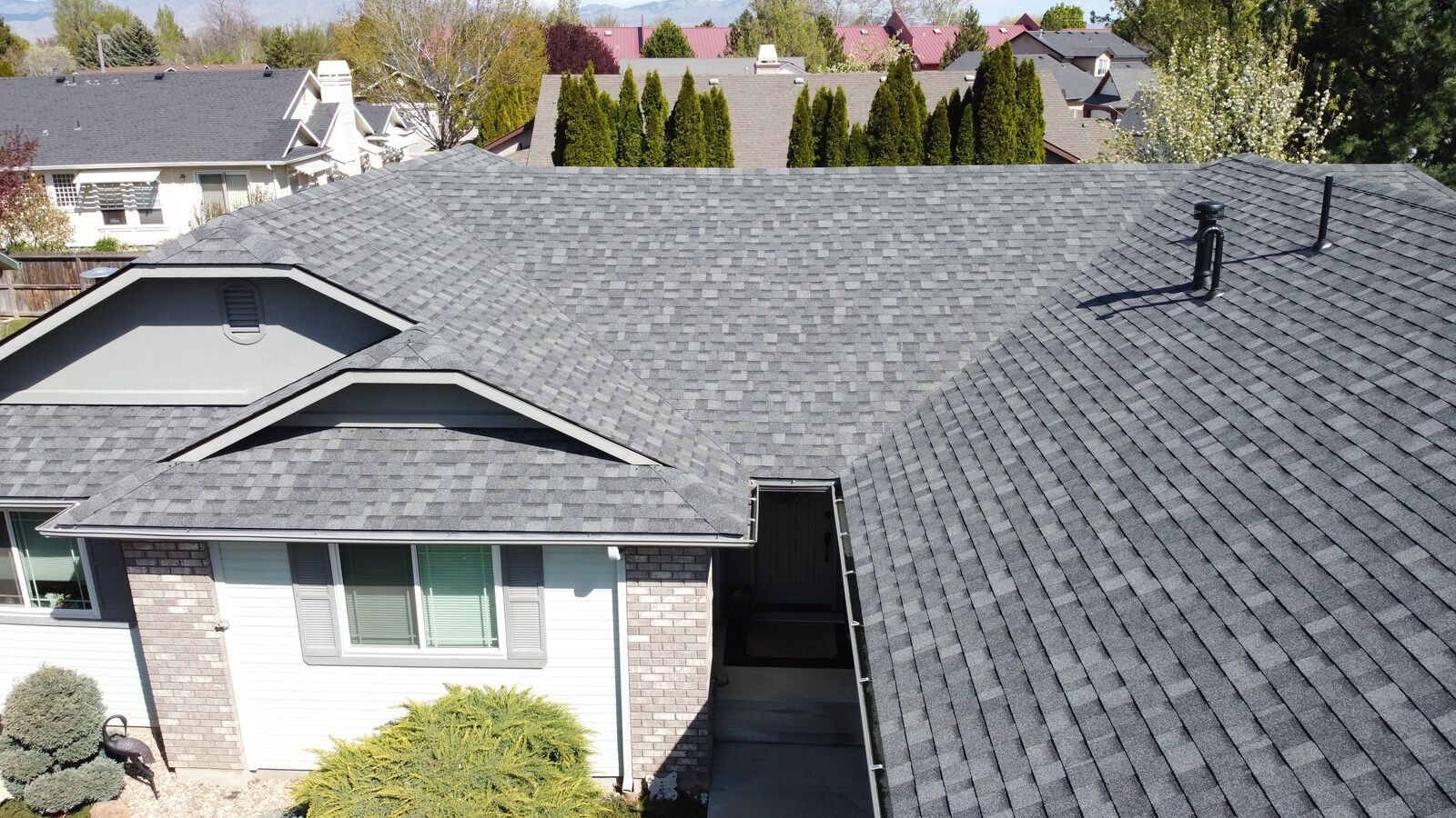 Grey shingle roof on brick home in Star Idaho by Blue Goat Roofing