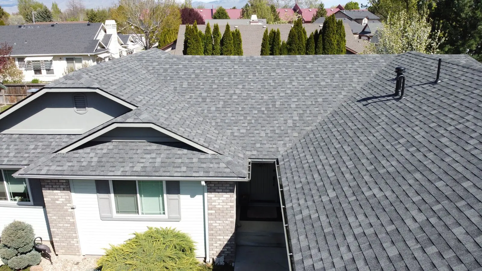 Grey shingle roof on brick home in Star Idaho by Blue Goat Roofing